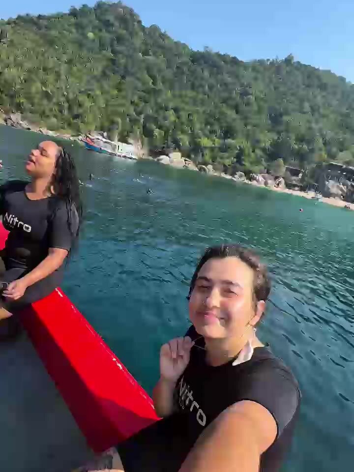 Two friends kayaking in a turquoise bay